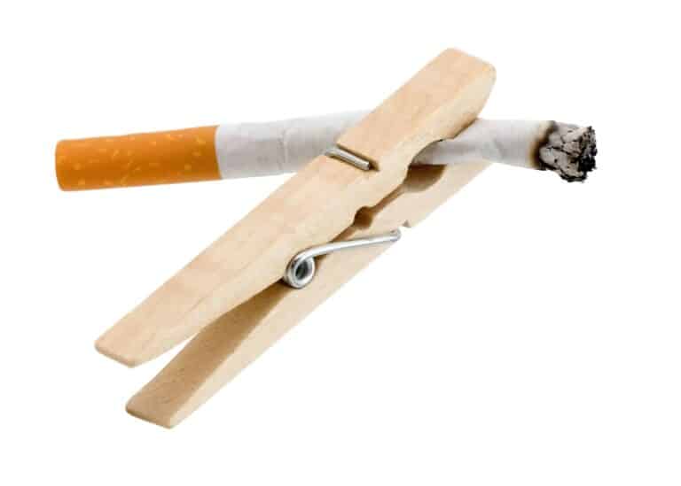 A wooden cigarette holder with a cigarette in it