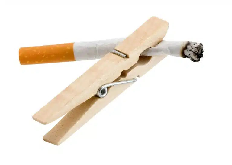 A wooden cigarette holder with a cigarette in it
