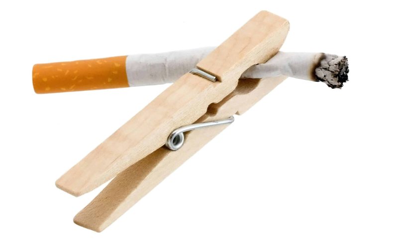 A wooden cigarette holder with a cigarette in it