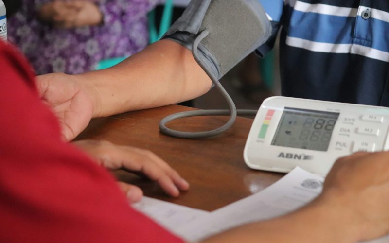 a person with a blood pressure meter on a table