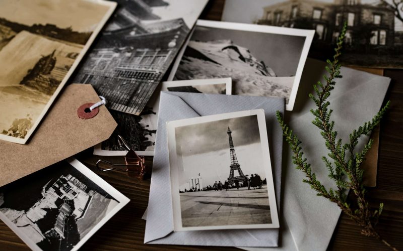 grayscale photo of Eiffel tower on top of white envelope